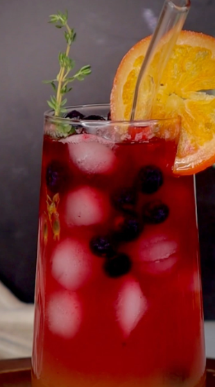 A close up of a drink with an orange slice