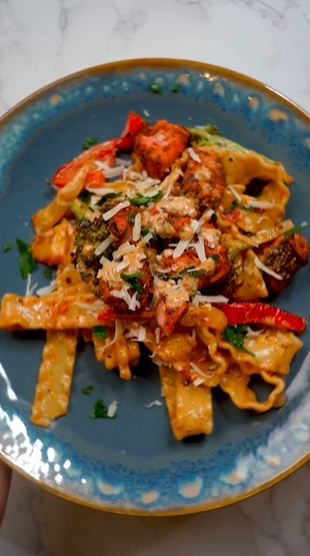 A plate of pasta with meat and cheese.