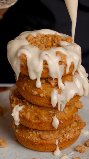 A stack of donuts with white icing on top.