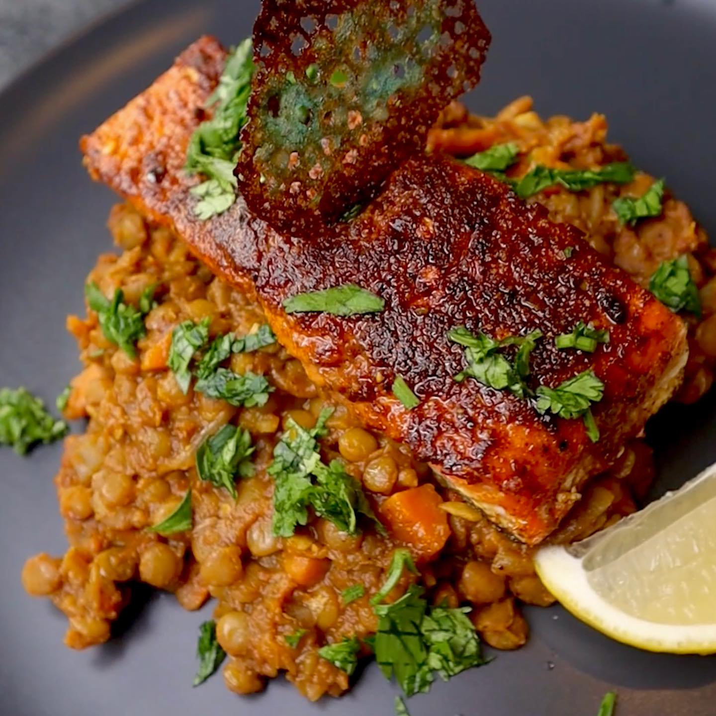 A plate of food with fish and lentils on it.