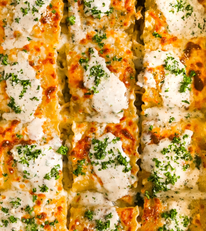A close up of some lasagna with cheese and broccoli