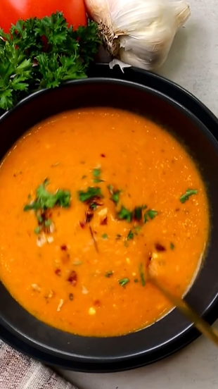 A bowl of soup with garnish in it.