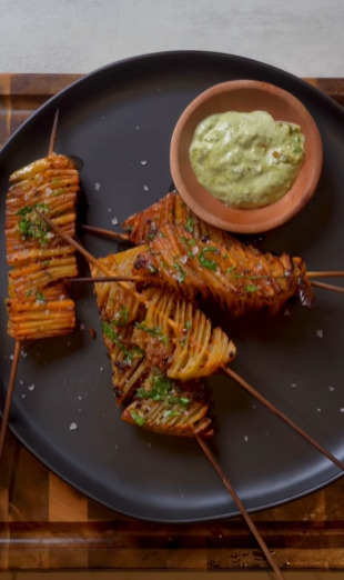 A plate of food with some potatoes and guacamole