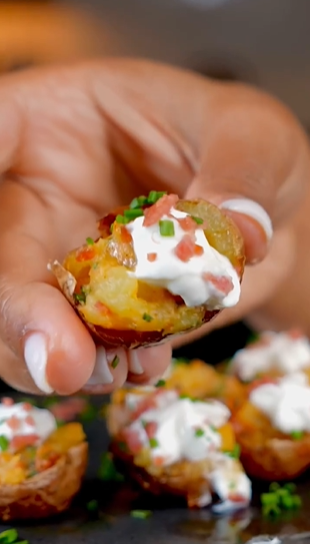 A person holding food with sauce on top of it.