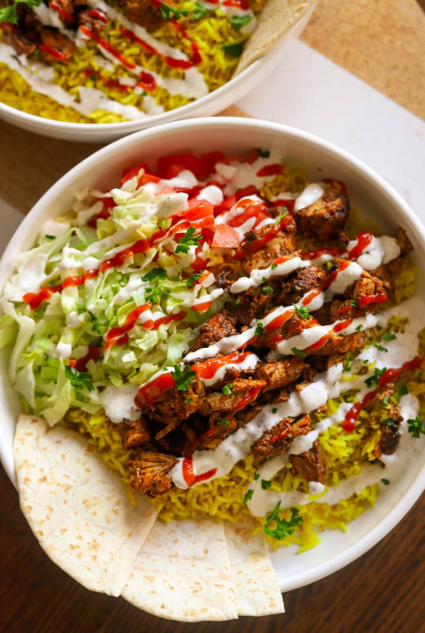 A bowl of food with rice and meat.