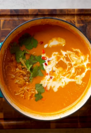 A bowl of soup with cilantro and other ingredients.