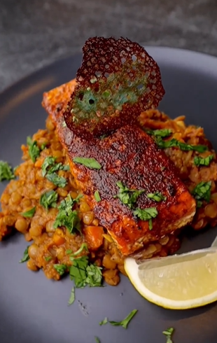 A plate of food with fish and rice on it.