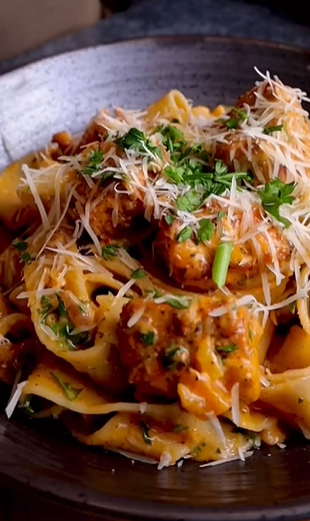 A close up of pasta with meat and cheese