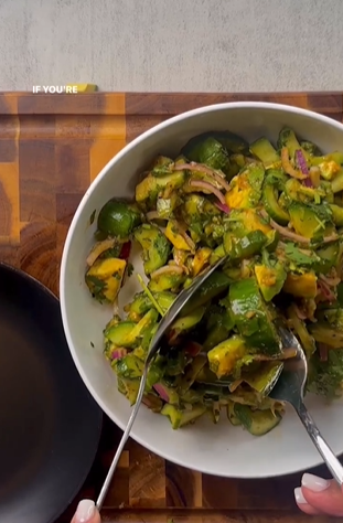 A bowl of salad with green and yellow vegetables.