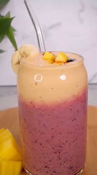 A smoothie with banana and blueberry in it.