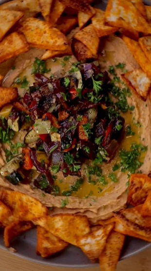 A plate of food with some vegetables on top