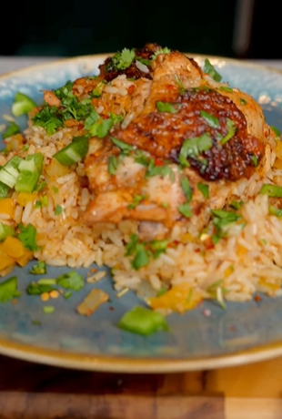 A plate of food with rice and meat on it.