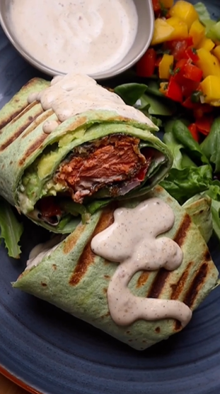 A close up of a burrito on top of a plate